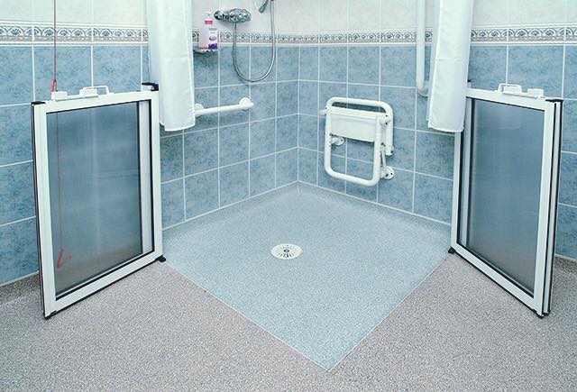 A disabled adaptaion wet room with cap and cove edging and hot welded joins between changing colours in the vinyl sheet safety flooring